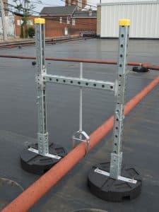 h-stand with clevis hanger supporting rooftop pipes